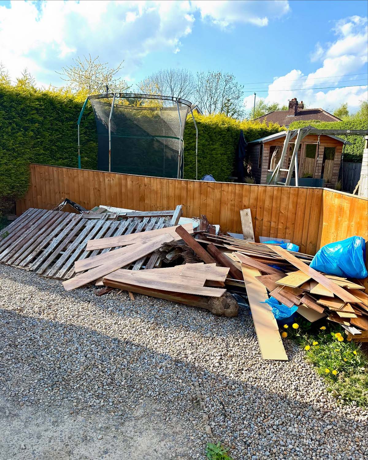 Old fencing waste piled up in a garden in West Yorkshire
